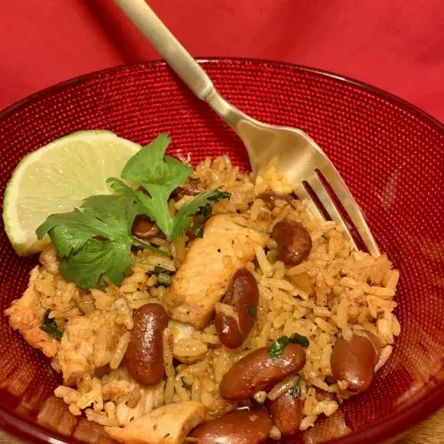 spanish rice in red bowl with fork